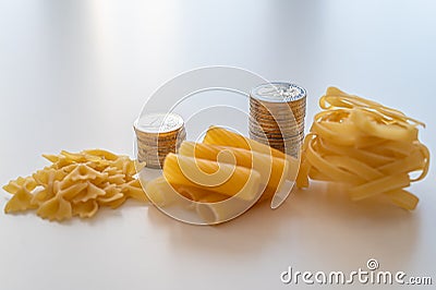 Pasta and stacks of money. Increase in the price of wheat and products. Stock Photo