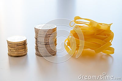 Pasta and stacks of money. Increase in the price of wheat and products. Stock Photo