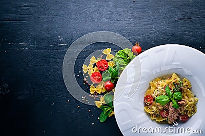 Pasta with tomatoes and basil. Plate with the word Stock Photo