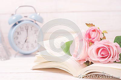 Pastel artificial rose and open book with vintage tone Stock Photo