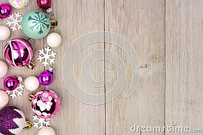 Pastel Christmas bauble side border on rustic white wood Stock Photo