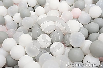 Pastel color white, grey, blue plastic balls background for baby activity. Kid's playing room interior. Copyspace Stock Photo