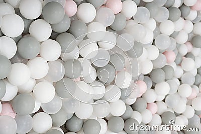 Pastel color white, grey, blue plastic balls background for baby activity. Kid's playing room interior. Copyspace Stock Photo