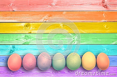 Pastel colorful rainbow painted eggs wood planks background Stock Photo