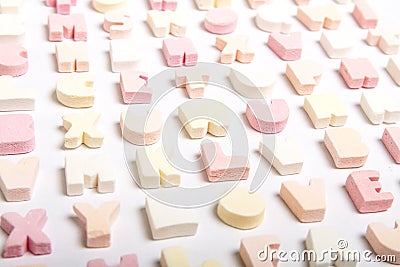 Pastel coloured candy letters arranged neatly against white background 2 Stock Photo