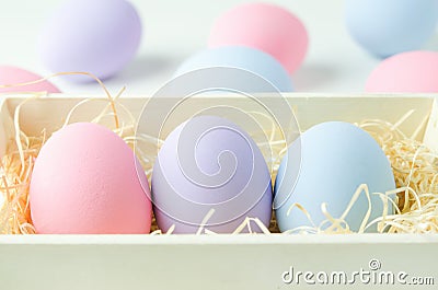 Pastel easter eggs at wooden basket Stock Photo