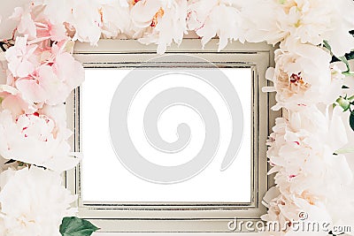 Pastel wooden frame decorated with peonies flowers, space for text. mock up Stock Photo