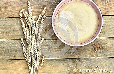 Pastery in a pink bowl with bunch of wheat spikes Stock Photo