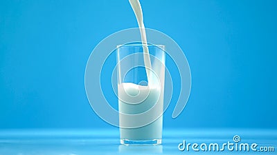 Pasteurized cow milk pouring in glass, organic nutrition, fresh food, calcium Stock Photo