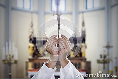 Pastor hands split a communion bread in church Stock Photo