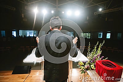 Pastor praying for congregation Stock Photo