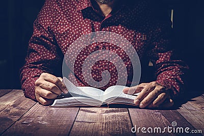 Pastor studying the Bible on a wooden desk Stock Photo