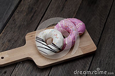 Glazed mini donuts on wooden background Stock Photo