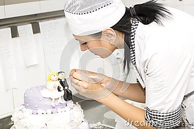 Pastry chef decorates a cake Stock Photo