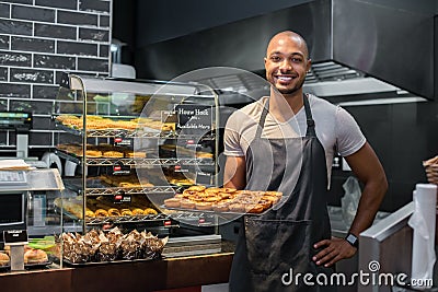 Pastry chef holding small pastry Stock Photo