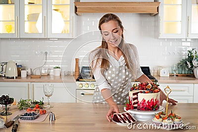 Pastry chef in the kitchen makes desserts, cakes and muffins. Cooking at home Stock Photo