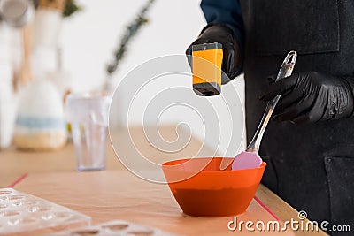 Pastry chef measures temperature of chocolate with laser thermometer Stock Photo