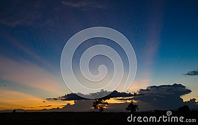 Pasture silhouette with a colorful sunset background Stock Photo