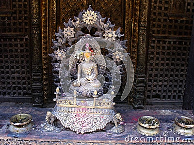 Altar with metal sculpture inside Hiranya Varna Mahavihar. Golden Temple. Patan, Kathmandu. Nepal Stock Photo