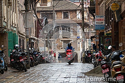 People Driving in the Rain in Kathmandu Patan Durbar Marg Editorial Stock Photo