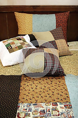 Patchwork quilt and pillows Stock Photo
