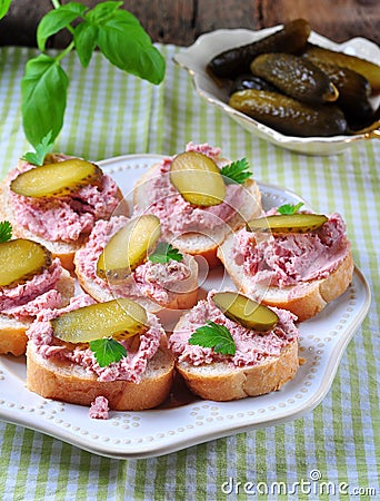 Pate with ham slice of cucumber, parsley, basil and coriander. Stock Photo