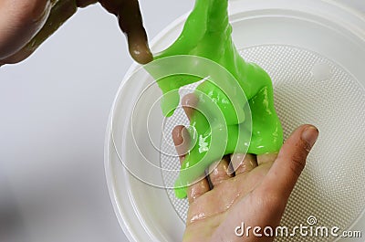 Pate slime elastic and viscous on child`s hand Stock Photo