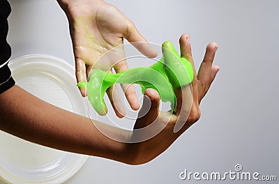 Pate slime elastic and viscous on child`s hand Stock Photo