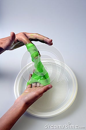 Pate slime elastic and viscous on child`s hand Stock Photo