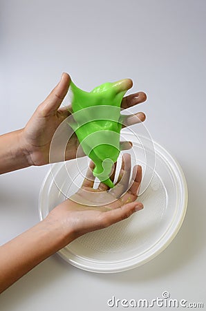 Pate slime elastic and viscous on child`s hand Stock Photo