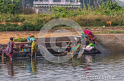 Women do the laundry in canal water, Patel Nagar, Karnataka, India Editorial Stock Photo