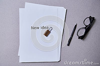 Patent , copyright or Intellectual protection concept: lock lying on a pack of sheets of paper with the inscription Stock Photo