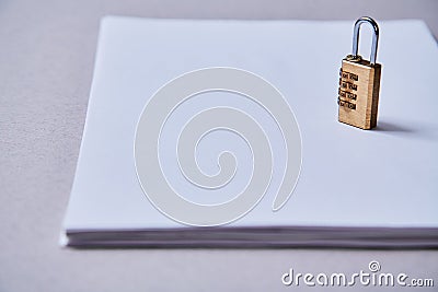 Patent , copyright or Intellectual protection concept: lock standing on a pack of sheets of paper with the inscription. Stock Photo