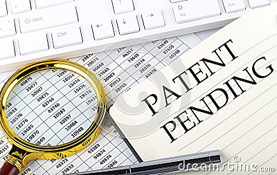 PATENT PENDING text on notebook with chart, magnifier,keyboard and pen Stock Photo