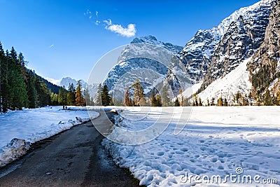 Path through early winter mountain landscape. Snow fall in the late autumn season Stock Photo