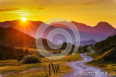 path in the mountains at sunset Stock Photo