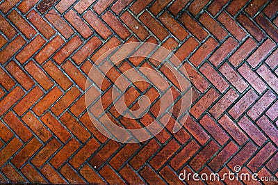 The path paved with red brick in herringbone pattern, Red stone walkway herringbone style pattern close-up Stock Photo