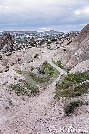 A path among the pink cliffs of Cappadocia. Tourism and travel. Beautiful landscape. Vertical Stock Photo