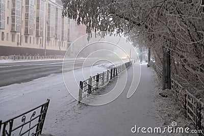 A path through snow-covered trees in Yakutsk city. Winter view of city Stock Photo