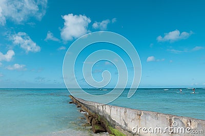 path walk way wall extend to clean blue sea on nice blue cloud sky vacation day. Stock Photo