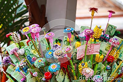 Pathum Thani, Thailand, -May,10,2017 : Thai buddhist people merit they money with insert money to stick they call 