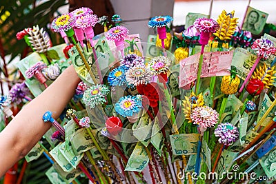 Pathum Thani, Thailand, -May,10,2017 : Thai buddhist people merit they money with insert money to stick they call 