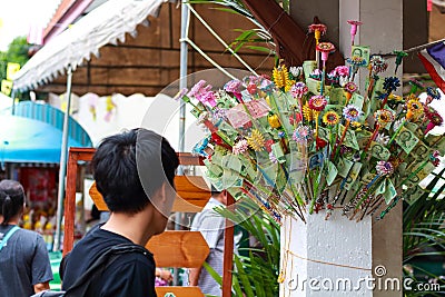 Pathum Thani, Thailand, -May,10,2017 : Thai buddhist people merit they money with insert money to stick they call 