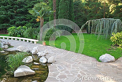 Pathway in garden, Green lawns Stock Photo