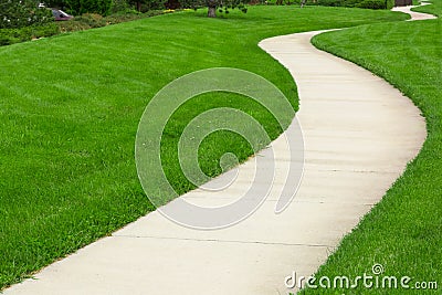 Pathway through green lawn Stock Photo