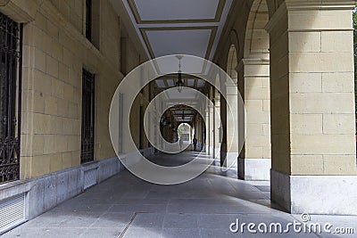 Pathway under the building with giant arches with pillars Stock Photo