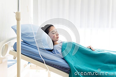 Patient asian woman sleeping under blanket on sickbed at the hospital Stock Photo