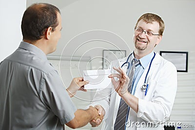 Patient bribing doctor Stock Photo