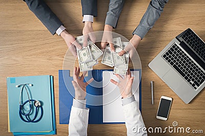 Patient bribing a greedy doctor Stock Photo