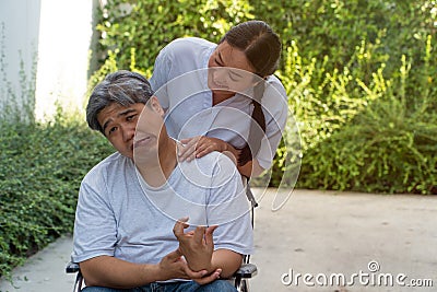 The patient is Cerebrovascular accident or stroke Caused by hypertension and obesity, sitting in wheelchair him mouse is facial pa Stock Photo